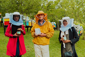 Image showing Portrait of Arab investors with a beekeeper in a large honey production farm