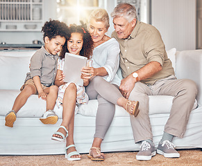 Image showing Social media, children and grandparents with tablet in a house, streaming cartoon or movie online. App, smile and interracial kids and senior man and woman with technology for a film, game or website