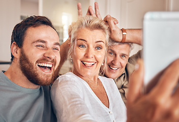 Image showing Man, senior parents and selfie in home, funny and peace sign for horns, bunny ears and laugh for post on web. Family house, people and memory with profile picture, photography and social network app