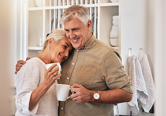 Image showing Coffee, love and retirement with a senior couple hugging in their home together while bonding in the morning. Kitchen, smile or romance with a happy mature man and woman drinking tea in their house