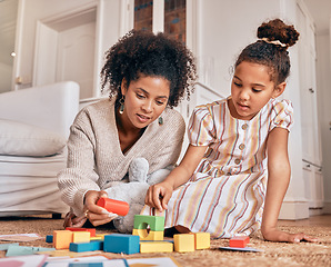 Image showing Family, education and building blocks with a daughter learning from her mother on the floor of their living room. Kids, growth and toys for child development with a woman teaching a girl at home