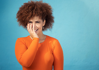 Image showing Happy, shy and young woman in studio with a positive, optimistic and innocent mindset. Happiness, giggle and excited female model from Mexico with smile posing while isolated by turquoise background.