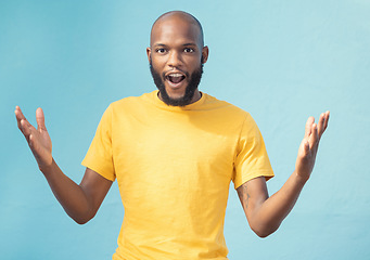 Image showing Portrait, wow and surprise with a black man in studio on a blue background feeling shocked or in awe. Announcement, news or gesture and a surprised male looking on in wonder with an omg expression