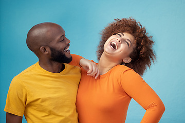 Image showing Love, laughing and interracial couple with a joke isolated on a blue background in a studio. Comic, funny and black man and woman smiling with happiness, care and confidence on a backdrop together