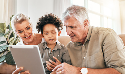 Image showing Family, grandparents and child on tablet in home e learning, online education and watch or streaming cartoon. Happy interracial kid and senior people on digital technology for teaching school on sofa