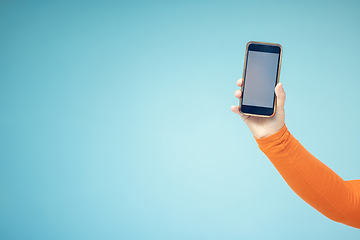 Image showing Woman hand, mockup screen and phone space advertising sale, promotion or brand website or internet. Person with smartphone on blue background studio for about us, online deal or network connection