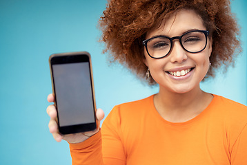 Image showing Phone screen, mockup and black woman isolated on blue background mobile app, social media or product placement. Portrait student, person or youth show smartphone for website or tech mock up in studio