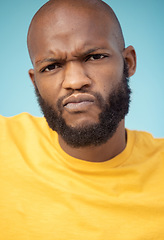 Image showing Portrait, doubt and expression with a black man in studio on a blue background feeling annoyed or frustrated. Face, confused and frown with a handsome young male indoor looking upset or unhappy