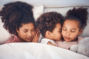 Image showing Mother, children and sleeping in bed together at home for security, bonding and comfort. Healthy, peace and a woman and kids nap, dream and rest or relax in a bedroom with love, care and safety