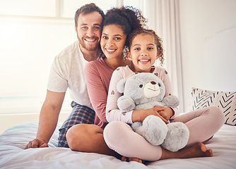 Image showing Portrait, bed and family with love, happy and relax with quality time, bonding and home with care. Parents, mother and father with child, bedroom and kid with mom, dad and happiness on weekend break