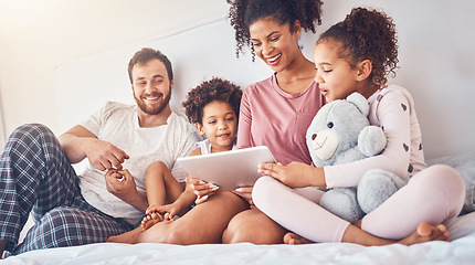 Image showing Happy family, bed and tablet streaming, movies or games while bonding, relax and play in their home. Online, subscription and children with parents in a bedroom for entertainment, fun and watching