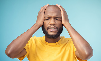 Image showing Fail, mistake and mental health with a black man in studio on a blue background feeling stress or anxiety. Compliance, burnout and oops with a handsome young man posing hands on head on a pastel wall