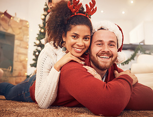 Image showing Christmas, portrait and happy couple in home on floor, bonding and together. Xmas, smile and face of man with African woman, interracial and enjoying time for party, celebration and winter holiday