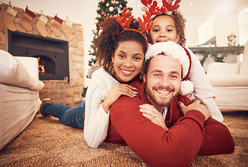 Image showing Christmas, happy family and portrait in home on floor, bonding and together. Xmas, smile and face of parents with girl, interracial and African mom with father for party, celebration and holiday