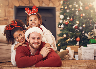 Image showing Christmas, portrait and happy family in house on floor, bonding and together. Xmas, smile and face of parents with child, interracial and African mother with father for party, celebration and holiday