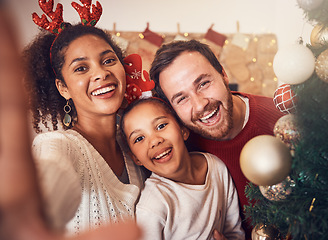 Image showing Christmas, happy family and portrait, selfie and funny together in home. Xmas, smile and face of parents with girl, interracial and African mom laughing with father for party, celebration and holiday