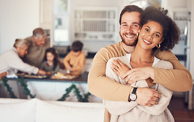 Image showing Couple, portrait and hug with love on christmas in family home for quality time with interracial people. Love, embrace and man or woman with happy face in kitchen for bonding during festive season.