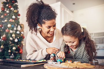 Image showing Baker, kid and mother on christmas with smile or teaching to make food in kitchen for celebration. Happy child, parent and education with cookies in home for festive season with learning for cooking.