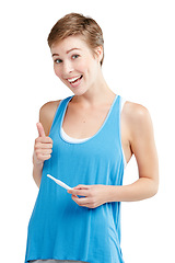 Image showing Portrait, thumbs up and pregnancy test with a woman in studio isolated on a white background for prenatal health. Pregnant, positive and emoji with an attractive young mother to be on blank space