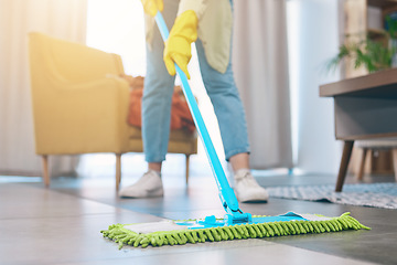 Image showing Woman, hands and cleaning floor with mop in living room for hygiene, bacteria or germ removal at home. Female person, housekeeper or maid in domestic service, dirt or dust for disinfection in house