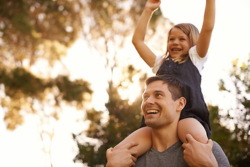 Image showing Higher dad. Shot of a father giving his adorable daughter a piggyback ride.