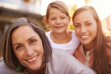 Image showing The girls enjoying some morning sunlight. Portrait of a grandmother, mother and granddaughter.