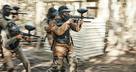 Image showing Teamwork, motion blur and paintball with man in game for playground, speed and gaming. Challenge, mission and soldier with people shooting in battlefield arena for target, gun and warrior training