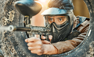 Image showing Paintball, shooting and man in action with gun for tournament, competition and battle in nature. Camouflage, military and male person aim in outdoor arena for training, adventure game or challenge