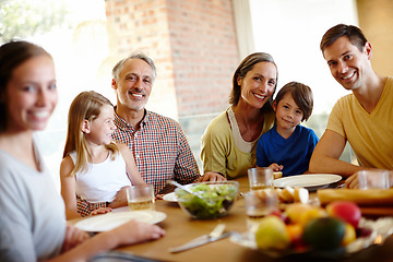 Image showing Home is where our family is. A portrait of a happy multi-generational family eating a meal together at home.