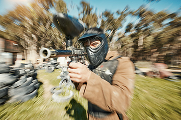 Image showing Paintball, shooting and gaming with man in playground for battlefield, mission or soldier with blur. Sports, games and fast with person and gun in arena for challenge, adventure and warrior training