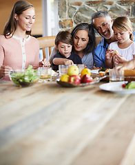 Image showing Healthy, nutritious and delicious. A happy multi-generational family sitting at a table and having lunch together.