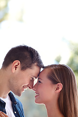 Image showing Theyre ready for forever. A young couple sharing an intimate moment outdoors.