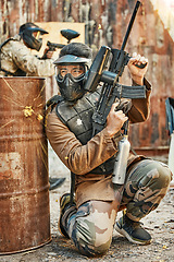 Image showing Paintball, soldier and man with gun for tournament, competition and battle in arena. Extreme sports, military and male person shooting in outdoor gear for training, adventure games and challenge