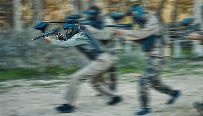 Image showing Paintball, shooting and teamwork with people in playground for battlefield, mission and soldier. Sports, games and fast with motion blur men and gun in arena for challenge, adventure and warrior