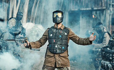 Image showing Paintball gun, man and war game with mask, camouflage clothes and gear for safety in outdoor combat. Military exercise, shooting and smoke on tactical adventure, battlefield and action with surrender