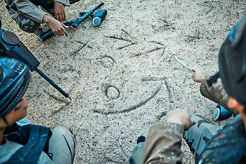 Image showing Paintball, battlefield and team with planning, mission and strategy drawing in sand with soldier group. War, gun and attack game plan with people outdoor, military tactics and army hero with teamwork