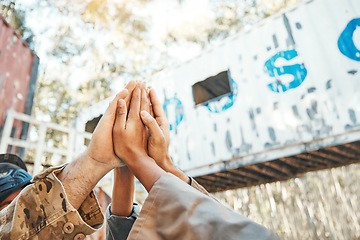 Image showing Paintball, hands and high five for support, motivation or teamwork in game plan, collaboration or unity on battlefield. Group of people touching hand in goal, team or trust together for match start