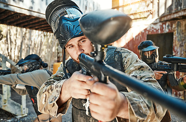 Image showing Paintball team, gun and man aim, focus or shooting at target, competition or battlefield conflict, fight or mission. Military group, hobby game or male shooter point weapon in war, training or battle