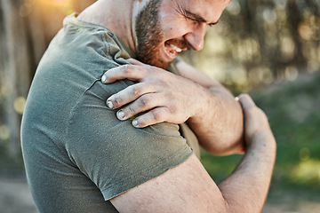 Image showing Man, outdoor and shoulder pain with fitness, injury and tension with sports, workout and accident. Male person, guy and athlete with injured arm, park and strain with inflammation with emergency