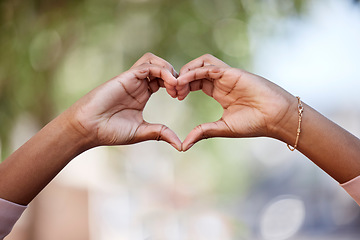 Image showing Woman, heart hands and love in nature for compassion, romance or care against a blurred background. Closeup of female person with loving symbol, gesture or sign for valentines day in the outdoors