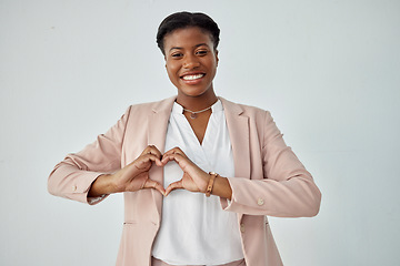 Image showing Happy black woman, portrait and heart hands for love, care or compassion against a white studio background. African female person with loving emoji, symbol and sign or hand gesture on mockup space