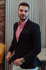 Image showing Portrait of a young businessman in a modern suit. Portrait of the company director in his office. Selective focus