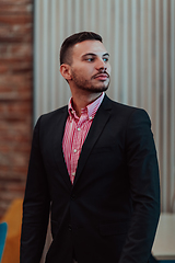 Image showing Portrait of a young businessman in a modern suit. Portrait of the company director in his office. Selective focus