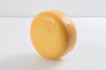 Image showing A piece of fresh processed cheese isolated on a white background