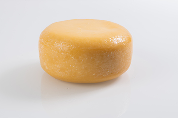 Image showing A piece of fresh processed cheese isolated on a white background