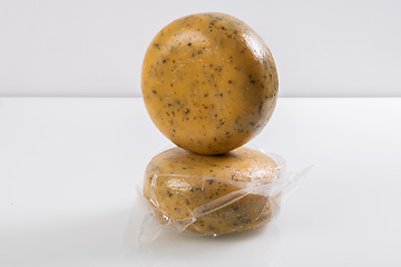 Image showing A piece of homemade vacuumed traditional Bosnian cheese isolated on a white background