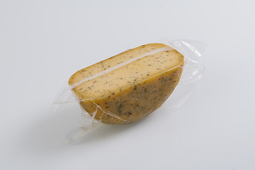 Image showing A piece of homemade vacuumed traditional Bosnian cheese isolated on a white background