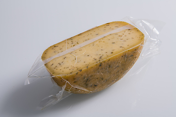 Image showing A piece of homemade vacuumed traditional Bosnian cheese isolated on a white background