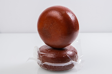 Image showing A piece of homemade vacuumed traditional Bosnian cheese isolated on a white background