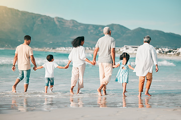Image showing Grandparents, parents or children holding hands at beach as a big family for holiday vacation travel together. Grandfather, grandmother or back of mom walking with dad, love or kids at sea to relax